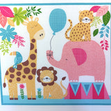 A giraffe is on the left with a toucan bird on its back with a lion and pink elephant and tiger