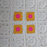 crochet granny squares in gold and pink and cream