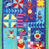 a quilt for a bed with fun, smiling red aliens and planets