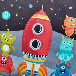 printed on to the front of the quilt are rockets, space boys and girls and monsters with a black background with stars on it