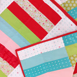 rectangular patches of red, green, pink, and blue fabric with hearts and flowers